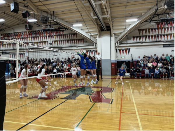 (Left to right) Ella Tsai '26, Abby King '27 and Blake Cussen '27 jump up for a block in game against Redwood. Girls varsity volleyball beat the Giants last Wednesday 3-0. 